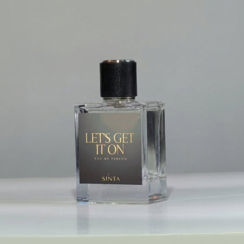 Perfume bottle labeled 'Let's Get It On' by Sinta on a gray background